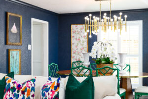 Looking over the couch on the cozy living room into a stylish, chic dining room of a Corpus Christi family home.