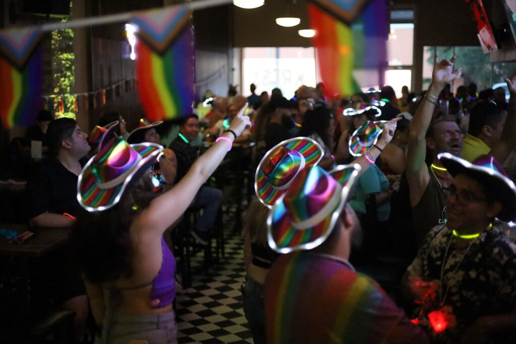 A group of people dancing at a bar in downtown Corpus Christi for the 2024 Pride Pub Crawl. 
