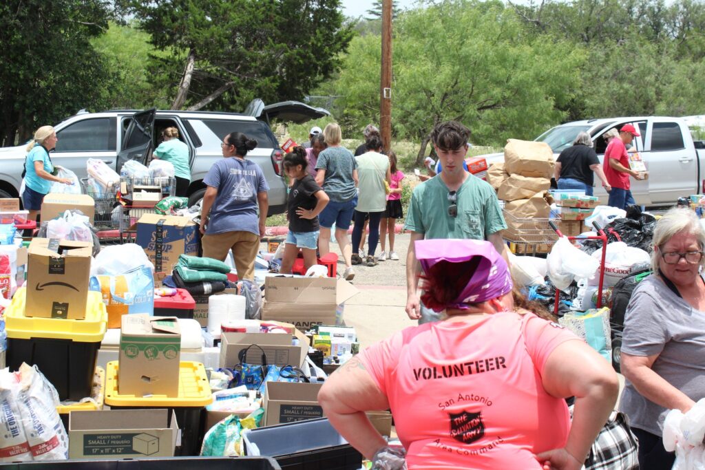 A group of volunteers pass out items via the Salvation Army in Kerville after the Hill Country and Central Texas floods. 