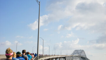 People walking over the old Harbor Bridge in Corpus Christi, Texas.