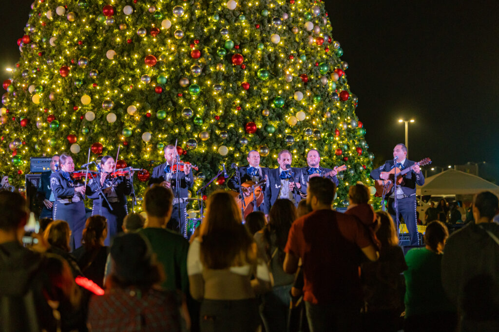 A mariachi band plays on stage in front of the H-E-B Christmas Tree in downtown Corpus Christi, Texas.