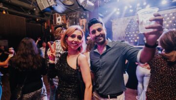 Two people pose for a photo at Gimmie Gimmie Disco.