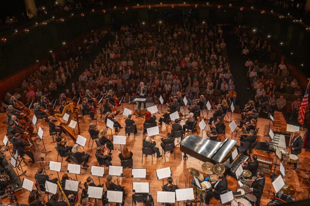 An aerial view of the Corpus Christi Symphony Orchestra performing on stage.