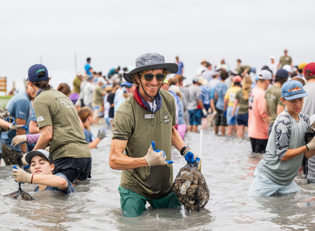 Senior Research Scientist Dr. Terry Palmer smiles at the camera during a recent Sink Your Shucks bagging event
